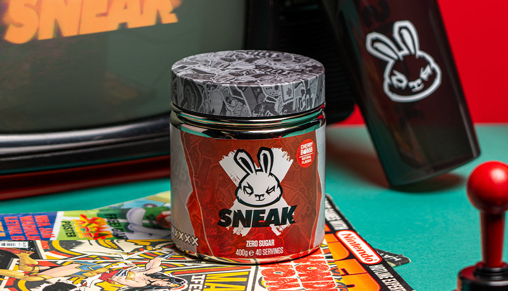 Sneak energy tub on top of Nintendo magazine next to retro television and joystick.